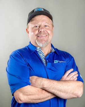 Shawn Sherrod wearing a blue company shirt.